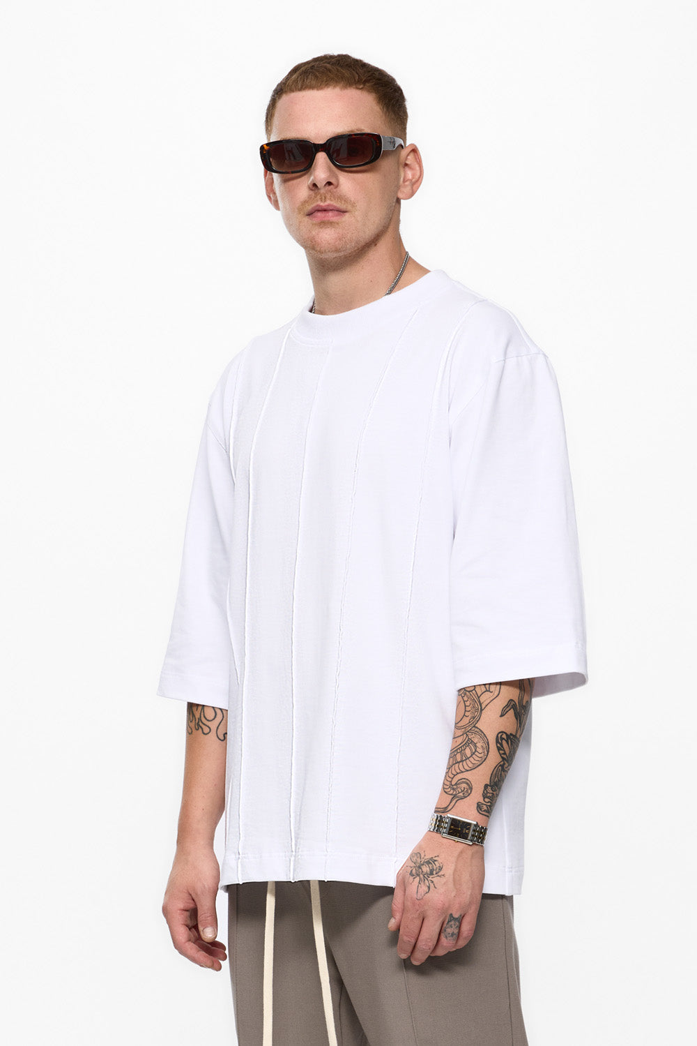 Man wearing a white t-shirt and sunglasses on a white background
